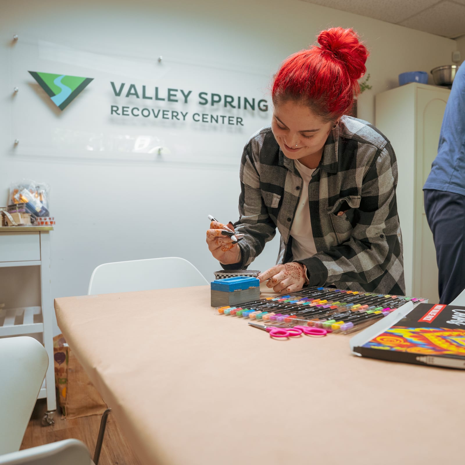 Arts and crafts group at Valley Spring Recovery Center A client paints during an arts and crafts group beneath the Valley Spring Recovery Center sign in Norwood, NJ