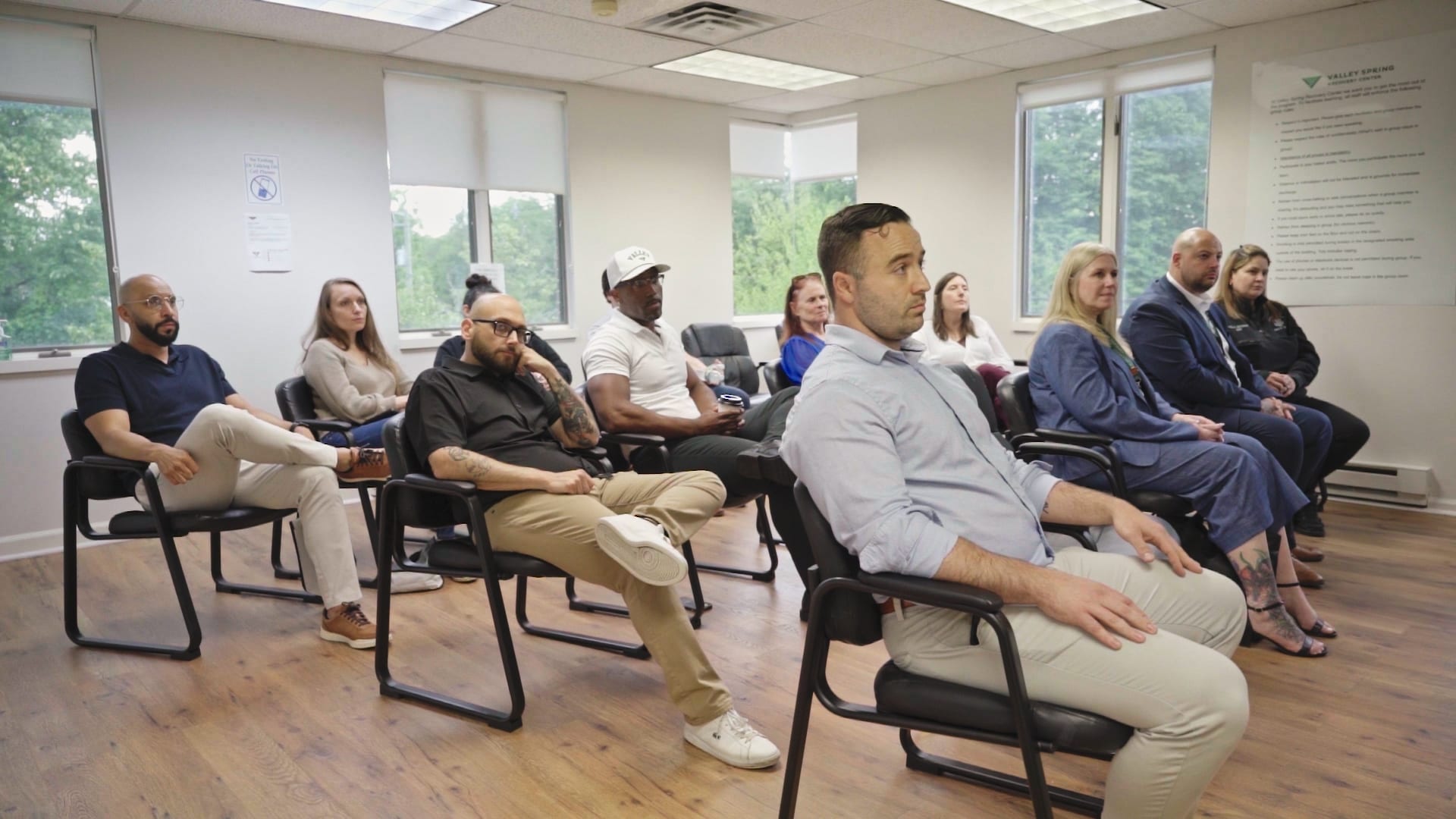The main group room at Valley Spring Recovery Center during an open house Guests and clinicians seated in the main group room at Valley Spring Recovery Center in Norwood, NJ